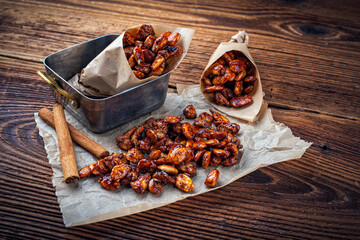 Candied almonds - homemade burnt sugar caramelized almonds served as close-up on backing paper