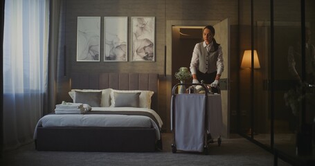 Hotel Maid Entering Elegant Hotel Room With Breakfast Trolley. in Cozy Interior With Stylish Decor,...
