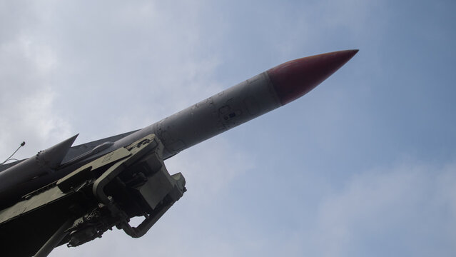 missile aiming upward, highcontrast scene showing missile with seeker tip and aerodynamic features