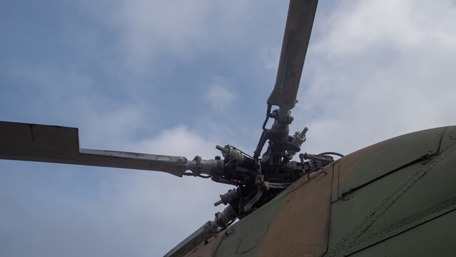 helicopter part overview, exposed helicopter rotor system showing blades and control mechanisms
