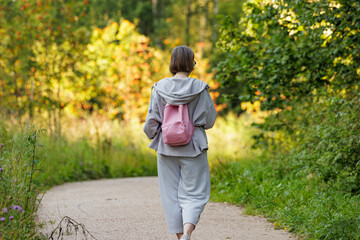 Exploring nature trails with a soft breeze and vibrant greenery in early autumn