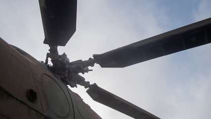 silhouetted helicopter rotor blades highlight readiness and force through motion and overcast...