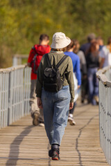 Enjoying a peaceful walk on a boardwalk surrounded by nature with friends on a sunny day