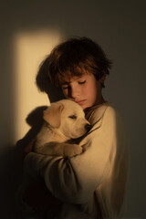 child lovingly kisses puppy goodnight surrounded by soft glow of nightlight