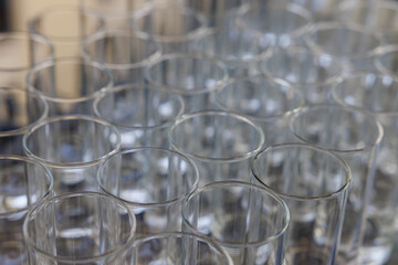 Gathering of clear glasses ready for a festive celebration or event at a lively venue