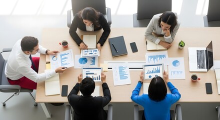 Business meeting concept with diverse team discussing charts and graphs at a conference table