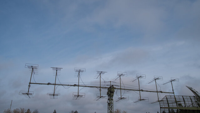 extended antenna view, scene showing longrange yagi antenna along communication tower during cloudy weather