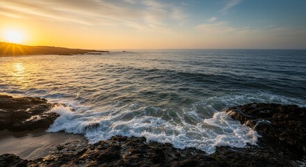 Sunset Over Ocean Waves Crashing on Rocks
