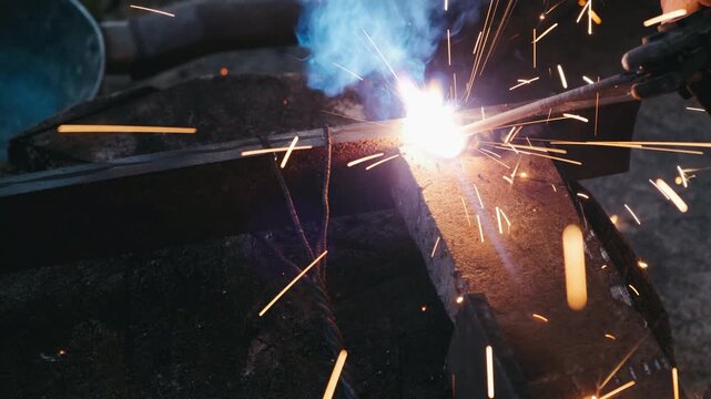 bright welding arc cutting steel, close-up of torch melting thick plate with blue-white flare, flying sparks and ember shower, smoky workshop