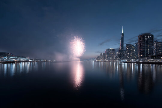 urban night celebration, city skyline at midnight with fireworks illuminating the sky, vibrant colors, and a festive atmosphere, reflecting in waterfront