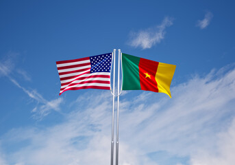 flags of  Cameroon and United States of America over blue sky background.