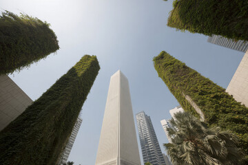 urban landscape featuring modern buildings adorned with green facades and vertical gardens