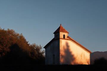 church is silhouetted against twilight sky exuding sense of peace and mystery