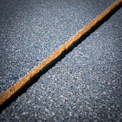 Textured crack in concrete pavement with golden light detail
