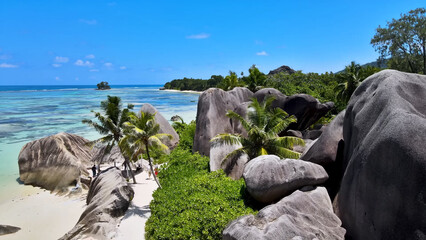 Luxury resort photo of Seychelles tropical paradise islands
in Indian Ocean with palm trees, sandy beach, stones.
Beautiful photography, coral reef, azure ocean, 
sky with clouds on horizon. 