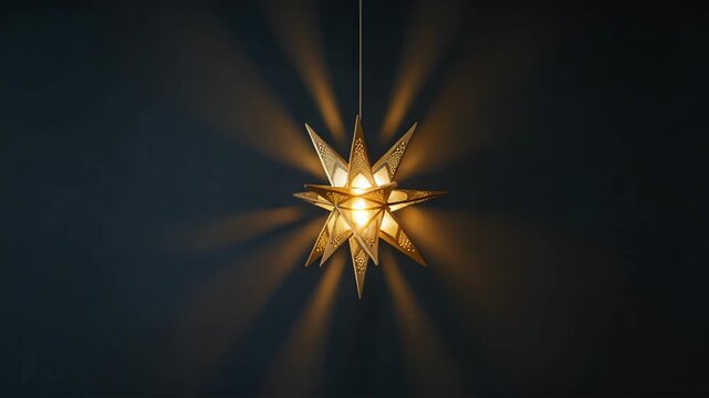 A radiant starshaped light fixture casts a warm glow in the darkness