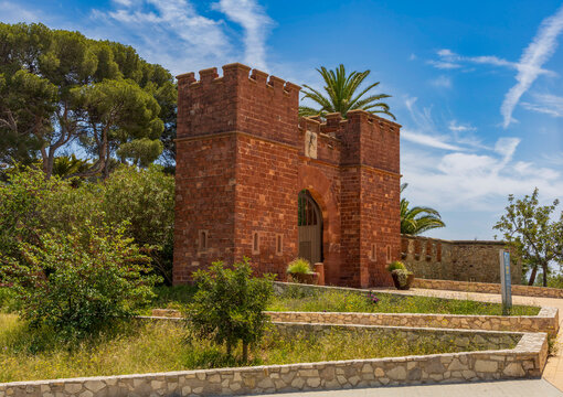 Exterior view of Castelldefels Castle, a 10th-century fortress on a sunny summer day