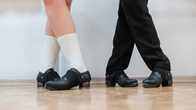 Close-up of female and male legs dancing traditional Irish stepdance. 