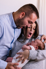 New parents seeing their newborn baby with surprise