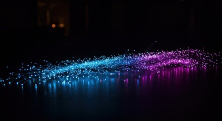 Blue and purple light strands on a reflective black surface