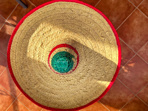 Top view of a taditional Mexican starw hat, sombrero with red brim