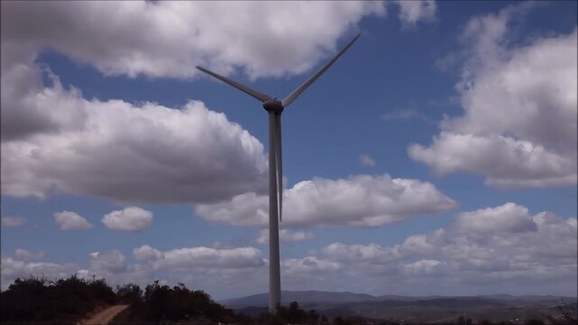 Wind turbine generator on top a hill for the production of clean and renewable energy near Fafe, Portugal