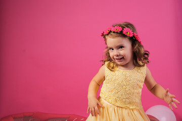 Little girl celebrating birthday party with pink flower crown