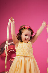 Little girl celebrating 3rd birthday with ribbons