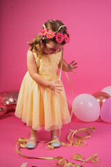 Young girl playing with ribbons at birthday party