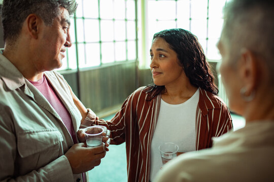 Adult friends in supportive conversation at community center