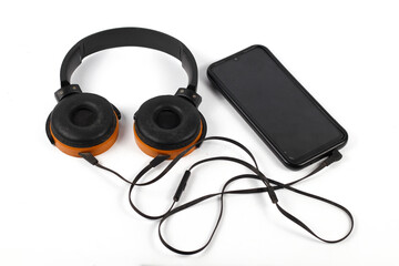 Still Life Modern Wireless Orange Headphones Connected to Smartphone isolated on white background