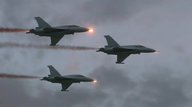 Bottom-view cinematic video of a trio of fighter jets flying in synchronized formation, engines glowing softly, sky illuminated by golden hour light