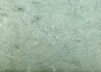 Vintage green stained paper texture. Old frayed antique sheet paper.