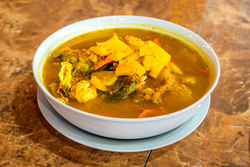 Gangan, a traditional fish soup from Belitung, Indonesia. This iconic dish is famous for its fresh, sour, and spicy yellow broth, often cooked with pineapple.