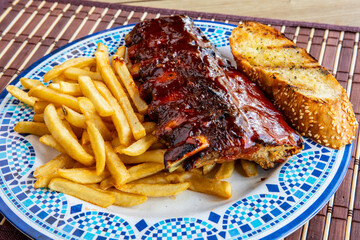 A half rack of pork ribs on fried with a slice of garlic bread toast diner style