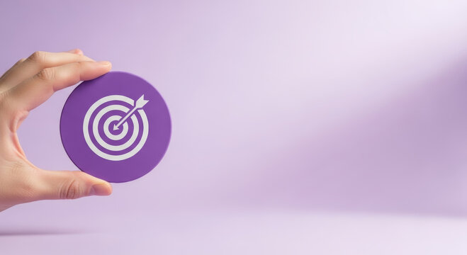 2026 financial goals business goals finance purple target concept hand holding icon focused planning motivation