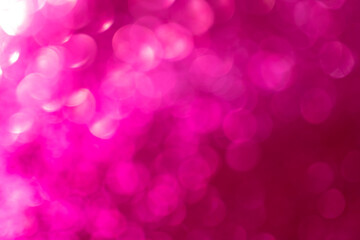 Christmas and New Year holiday card background.Pink bokeh background.shimmering circular pattern. Iridescent wallpaper in pink tones.