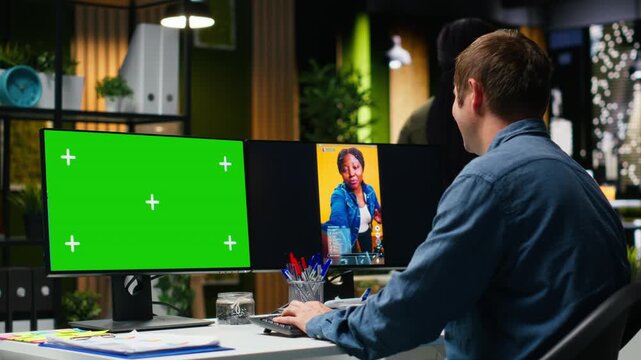 Mockup next to marketing analyst editing smartphone video footage on dual monitors, applying professional tools for video creation. Targeting algorithm shifts for engagement and reach. Camera B.