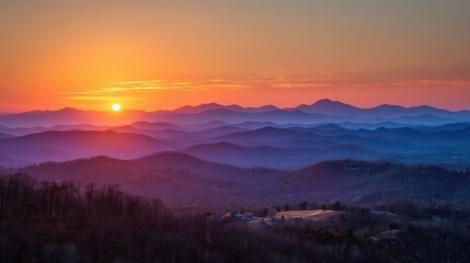 Obraz premium Sunset Over Mountain Range Displaying Vivid Colors and Atmospheric Haze