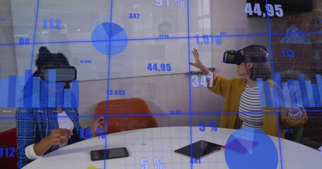 Two women in VR headsets, left tapping tablet, right sweeping, manipulating AR charts for tech demo