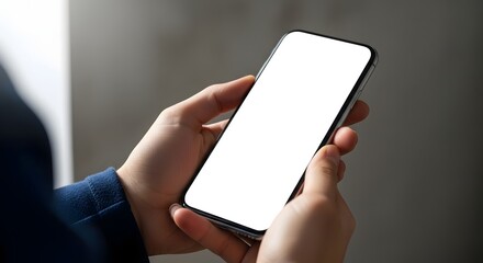 Close-up of hands holding a modern smartphone with a blank white screen.