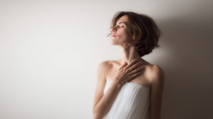 woman stands gracefully with her hand on her chest and eyes closed embodying tranquility and peace