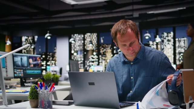 Startup employee consulting on a new corporate project with charts and files in the workspace, staff aligning targets with performance metrics for resource allocation and reports. Camera A.