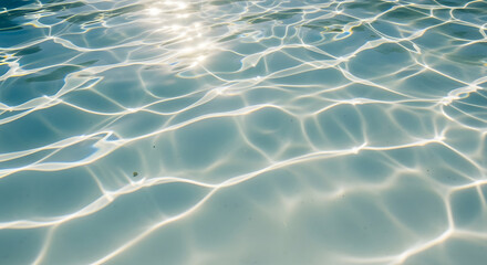 Sunlight dances and refracts through clear, turquoise water, creating bright, shimmering patterns across the surface, evoking a sense of calm, aquatic serenity in a tranquil scene. The effects appear