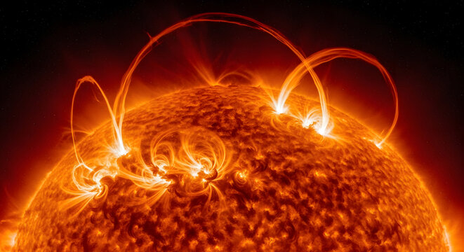 A visually striking image of the sun showcases its dynamic surface with intense heat and solar flares erupting against a backdrop of dark space with dispersed stars, conveying immense energy and