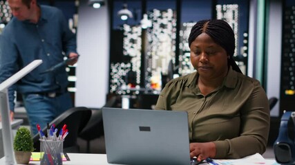 Multiethnic budgeting team reviewing numbers and sales on computer, working on resources allocation and making projections. Forecasting techniques for business success. Camera B.