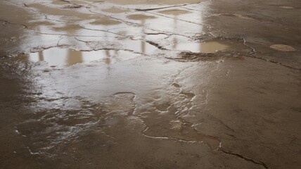 Urban puddle with light reflections on cracked concrete. AI generated