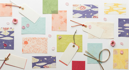 Flat lay of washi papers in hina colors with plain tags and strings