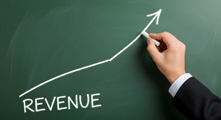 Hand drawing revenue growth chart on a green chalkboard with chalk illustrating business success and financial increase showing positive trends and economic development in a visual representation