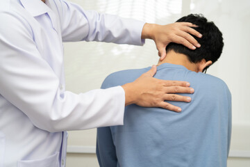 Physical therapy, Asian therapist doctor treat perform pain young man in hospital.